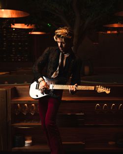 A musician playing electric guitar at Toca Madera Scottsdale showcasing its live music atmosphere and stylish interior.